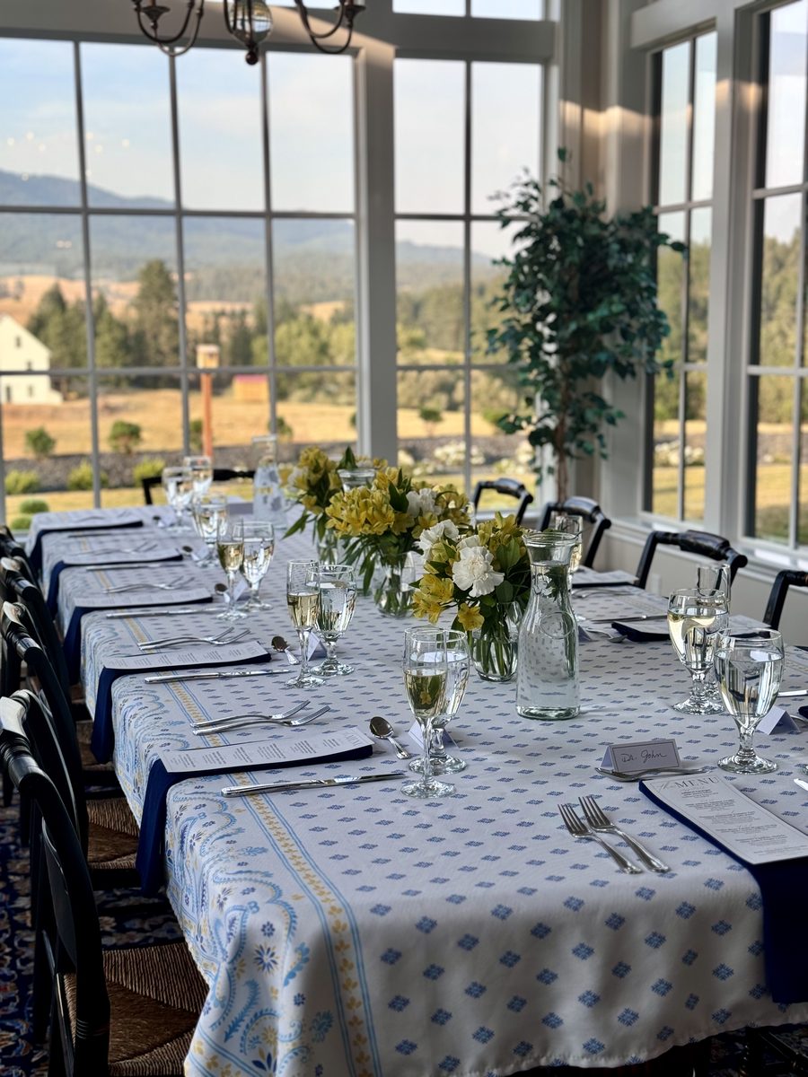 Venue setup with table service and florals